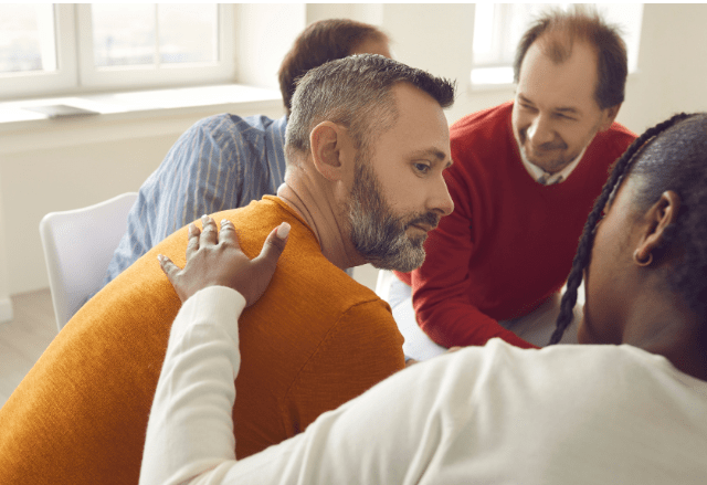 man in therapy talking to doctor