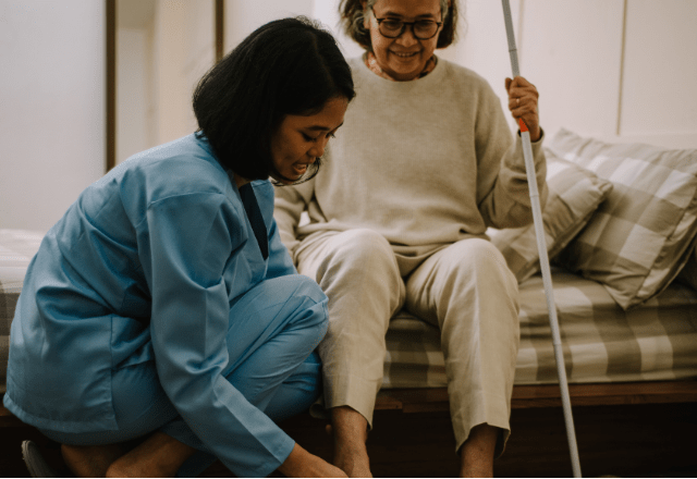 caregiver helping woman with therapy