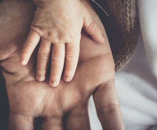 hands of a father and his son