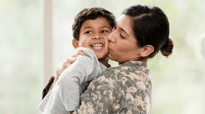 woman in military with young child