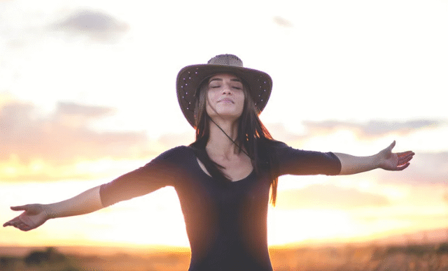 girl standing with hat